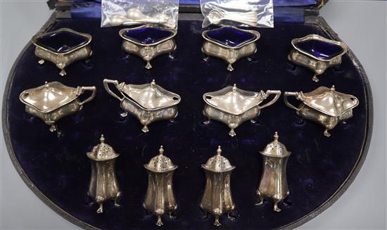 An Edwardian twelve piece silver condiment set, by Alexander Clark Co, Birmingham 1909, with eight